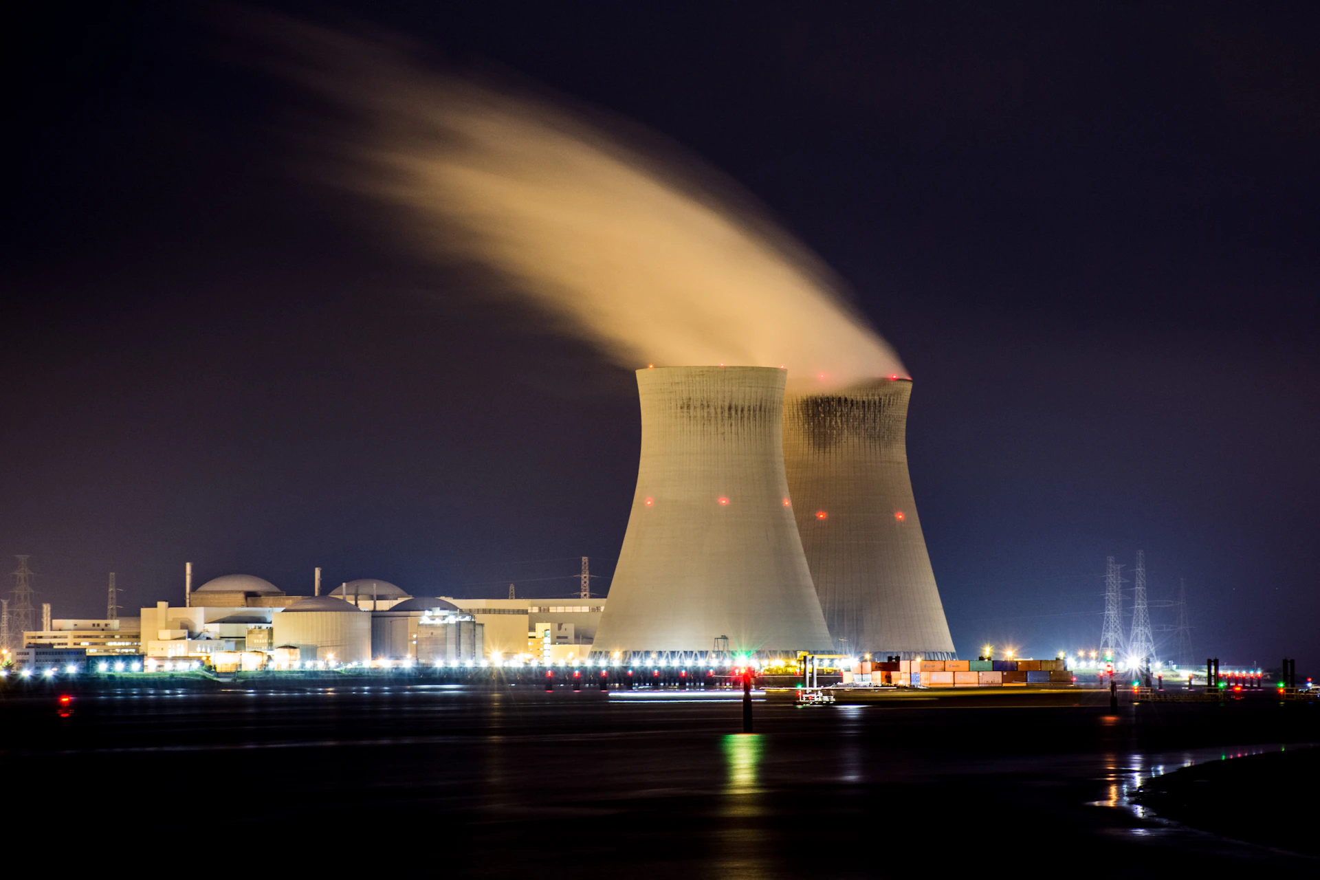 Illuminated power generation facility with industrial energy infrastructure at night