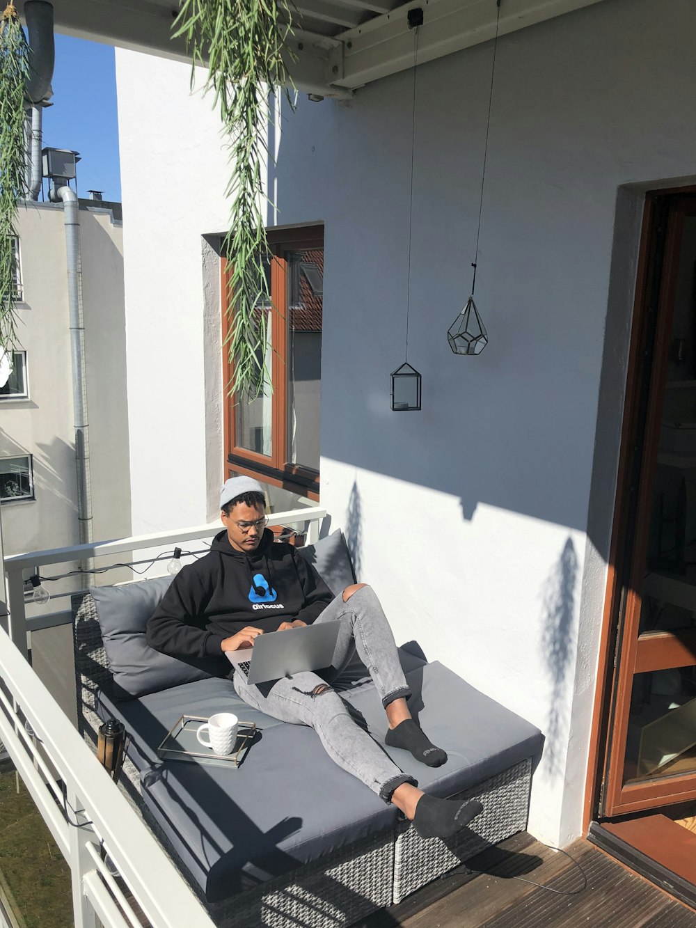 man in black jacket sitting on couch