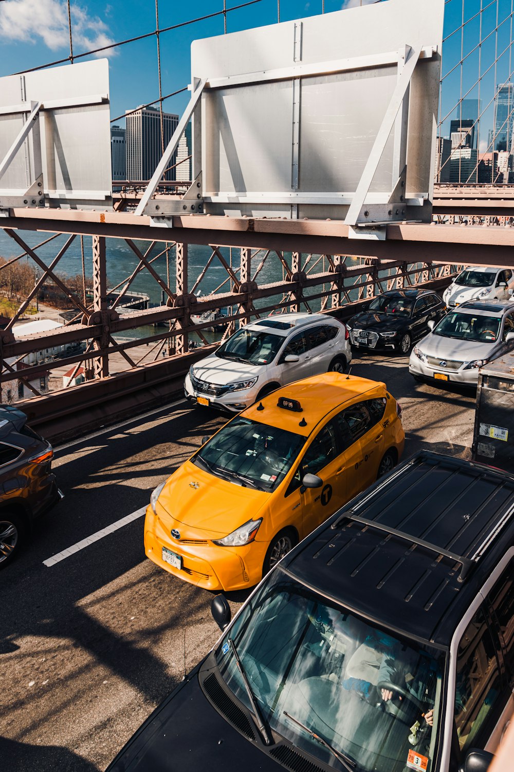 yellow car on gray concrete bridge during daytime