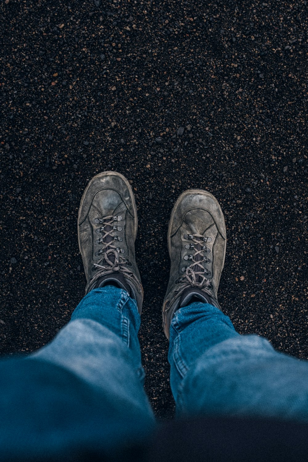 person in blue denim jeans and black hiking shoes