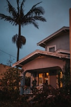 A welcoming Indian-style home porch glowing warmly at sunset.