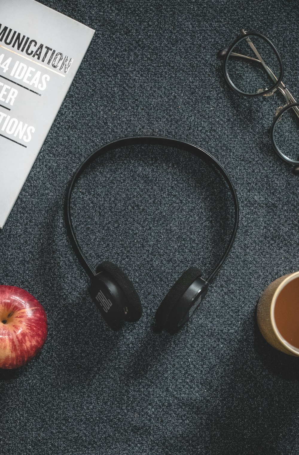 black headphones on black surface