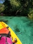yellow kayak on green body of water during daytime