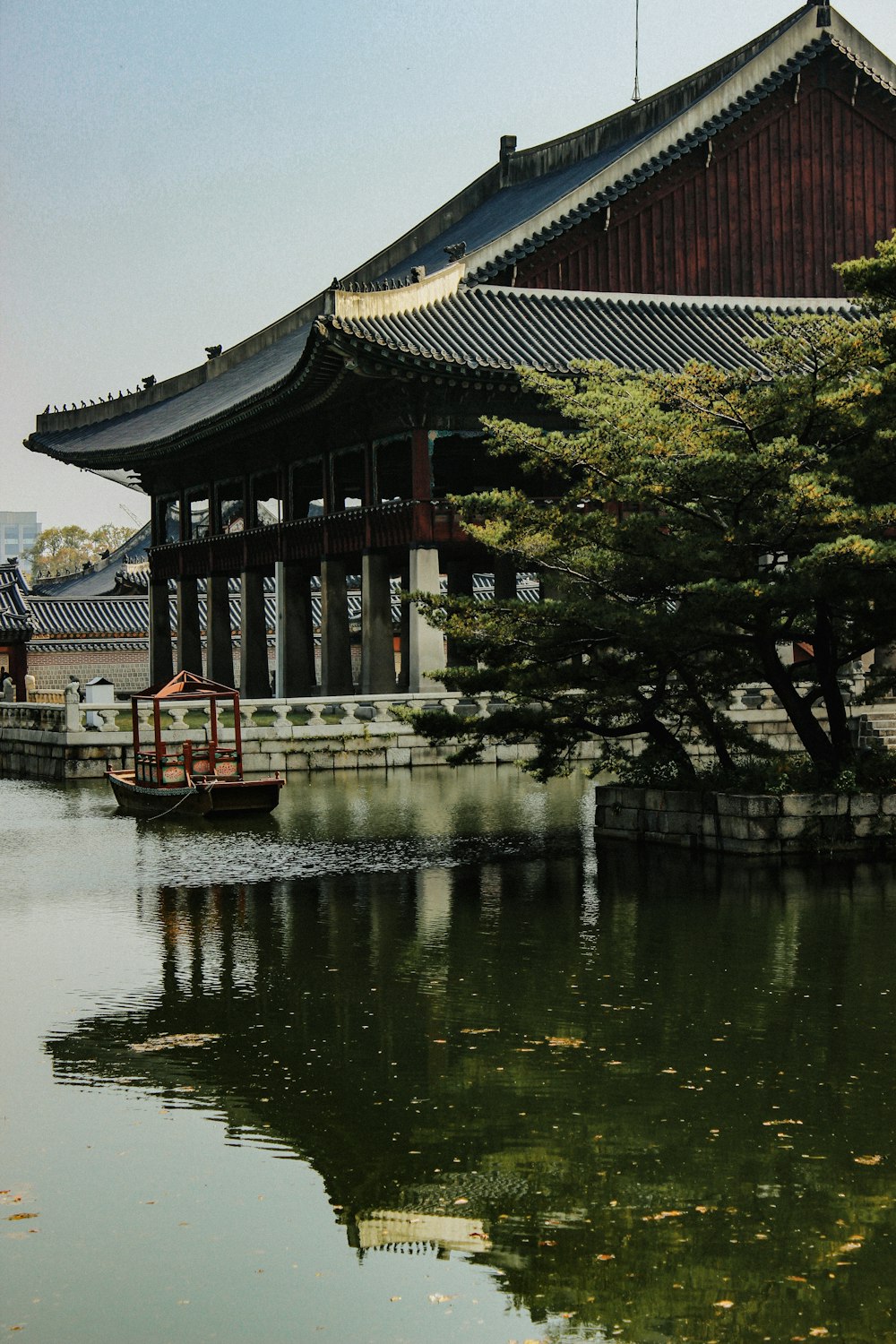 brown and white wooden house near body of water during daytime