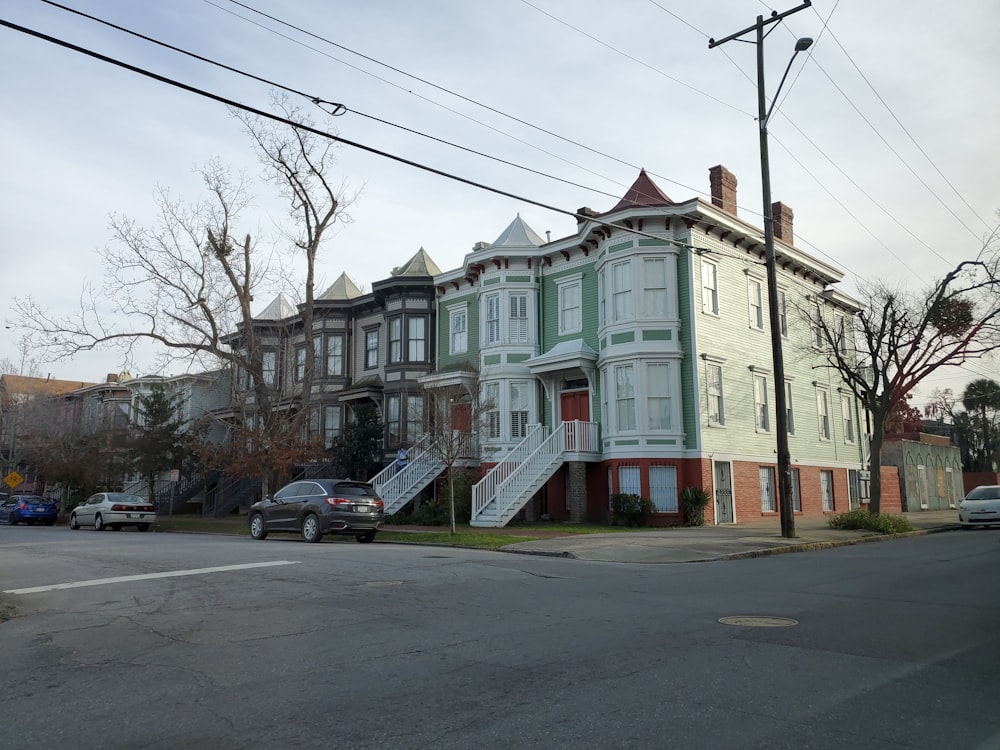 cars parked in front of white concrete building during daytime