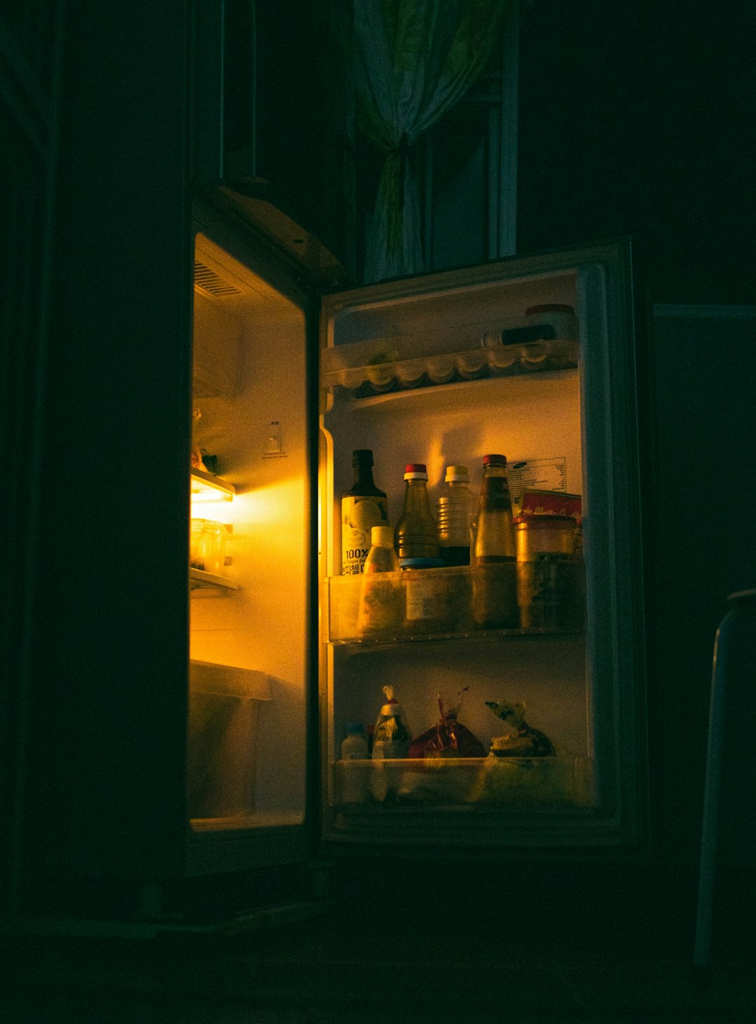 white refrigerator with bottles inside