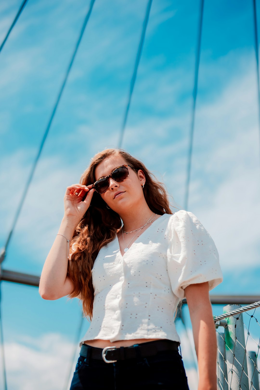 woman in white floral shirt wearing sunglasses
