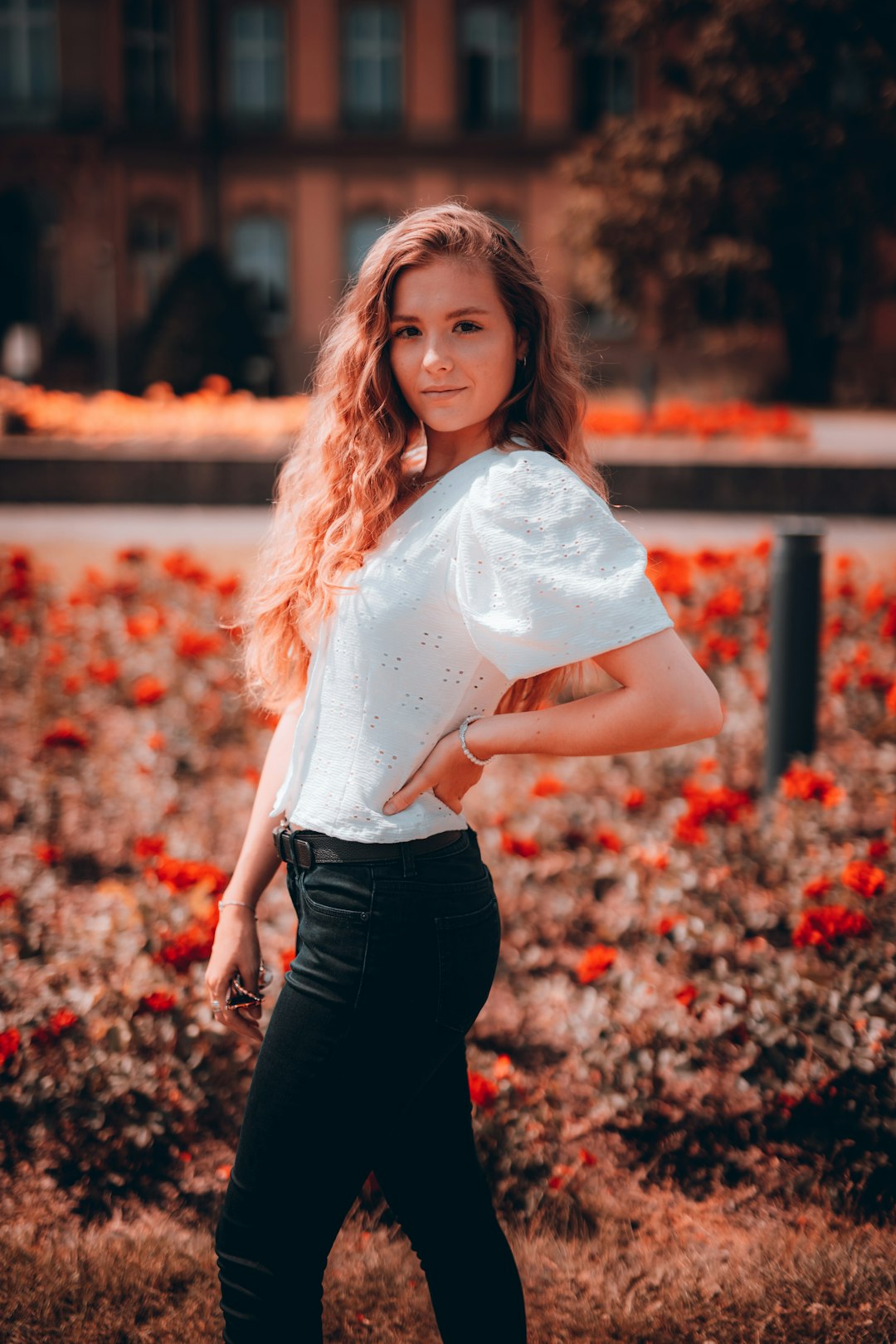 woman in white shirt and black pants holding white textile