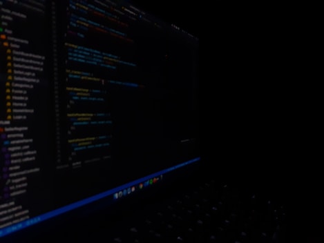 Close-up of a developer coding AI workflows on a dark-themed screen with luminous teal accents.