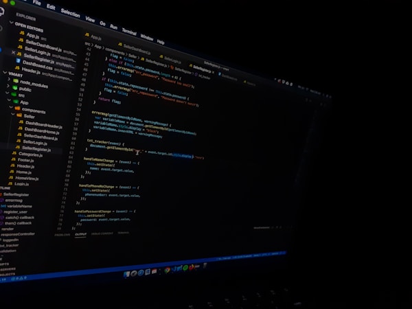 A computer screen displaying a code editor with visible syntax highlighting. The editor shows various files listed on the left panel and a JavaScript file open with lines of code visible. The environment appears to be a dark-themed setting.