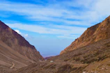 A rugged 4x4 trail winding through rocky terrain with panoramic mountain views.