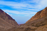Adventure-packed scene from Spiti Valley showing rugged terrain and a winding mountain road.