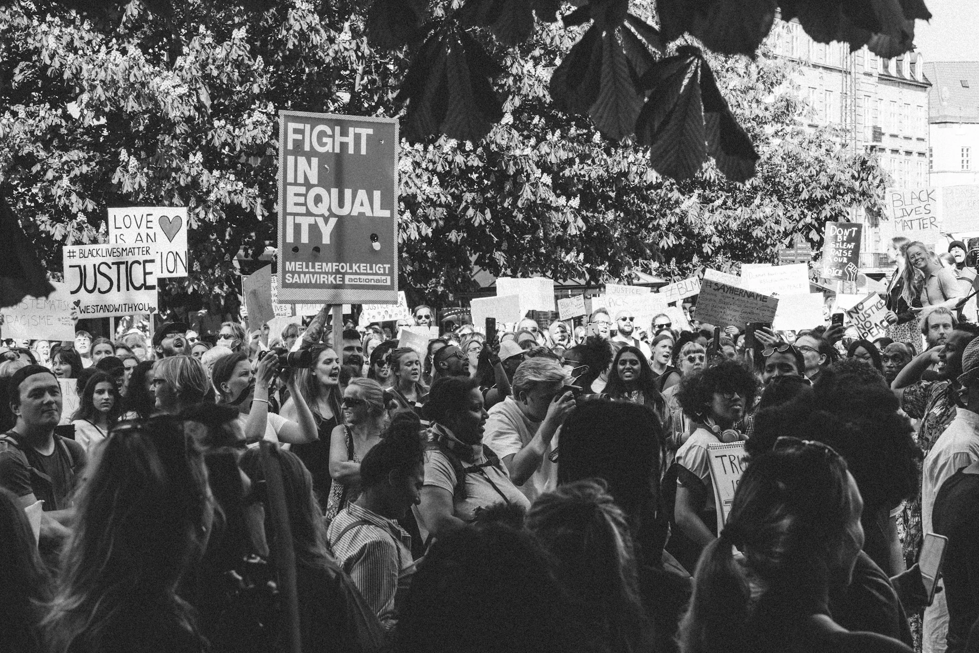 grayscale photo of people gathering on street