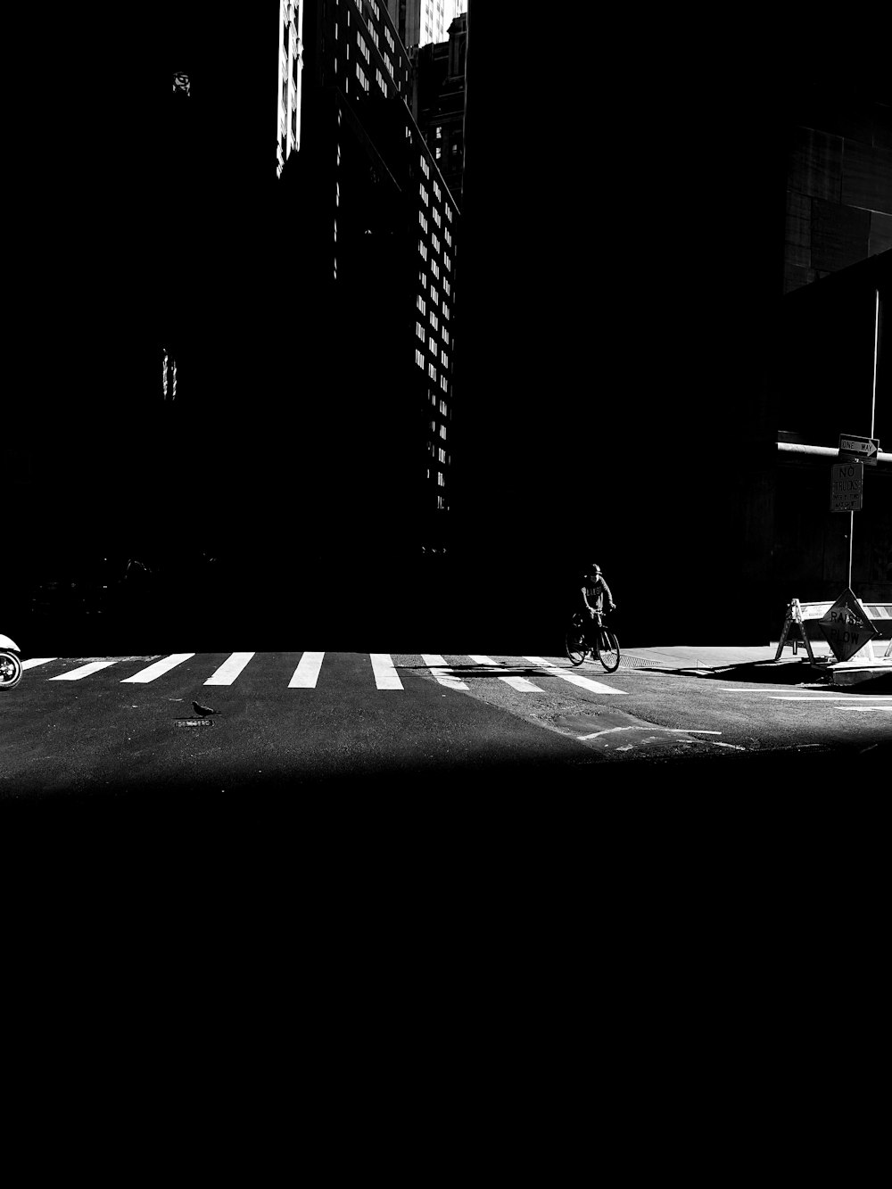 grayscale photo of man sitting on bench