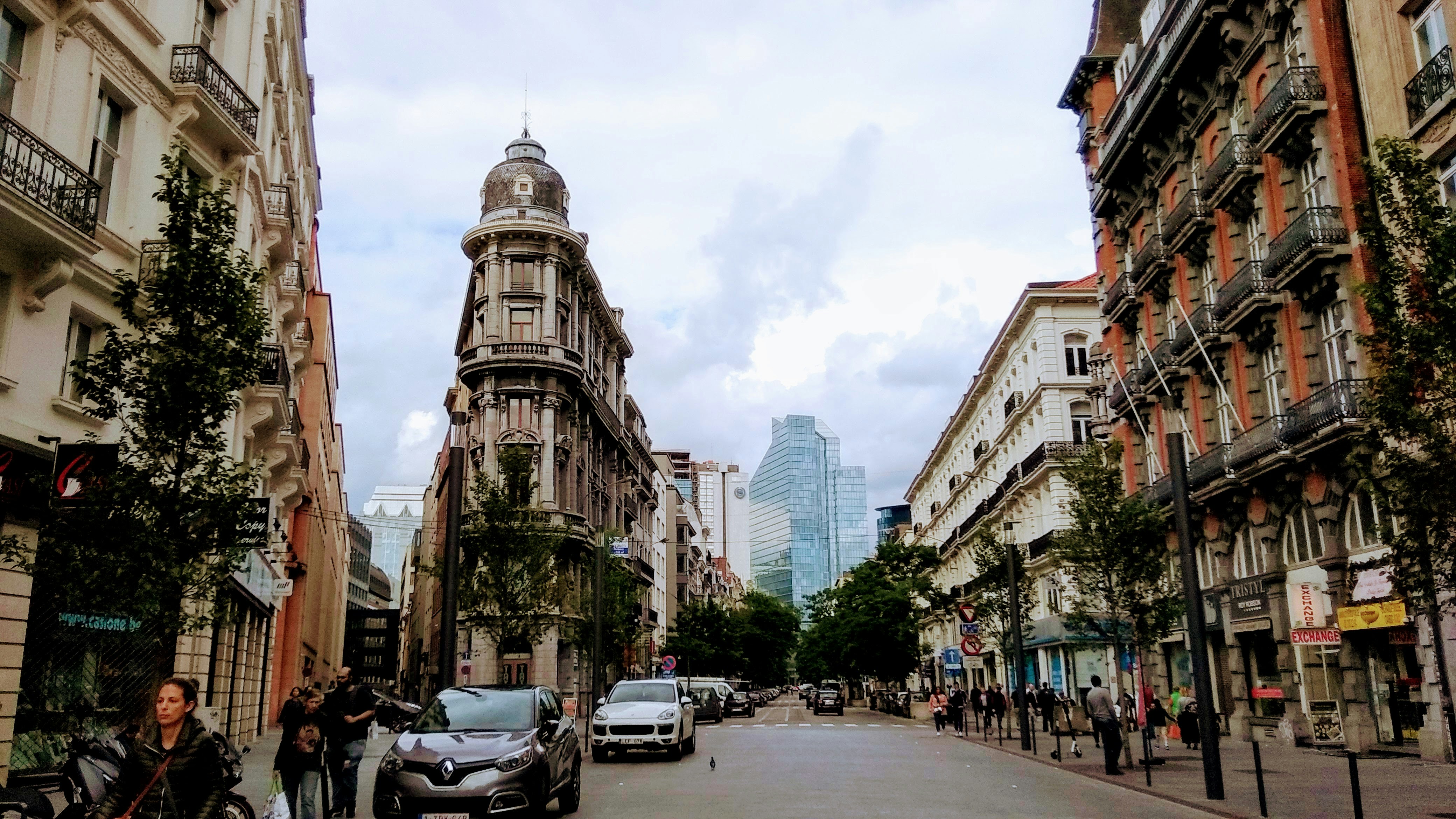 cars parked on street near high rise buildings during daytime