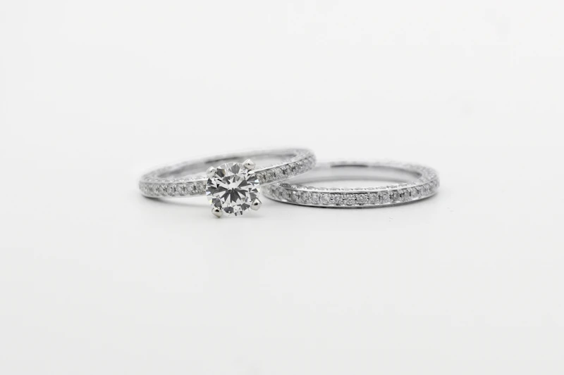 Round-cut diamond solitaire engagement ring shown with a matching wedding band