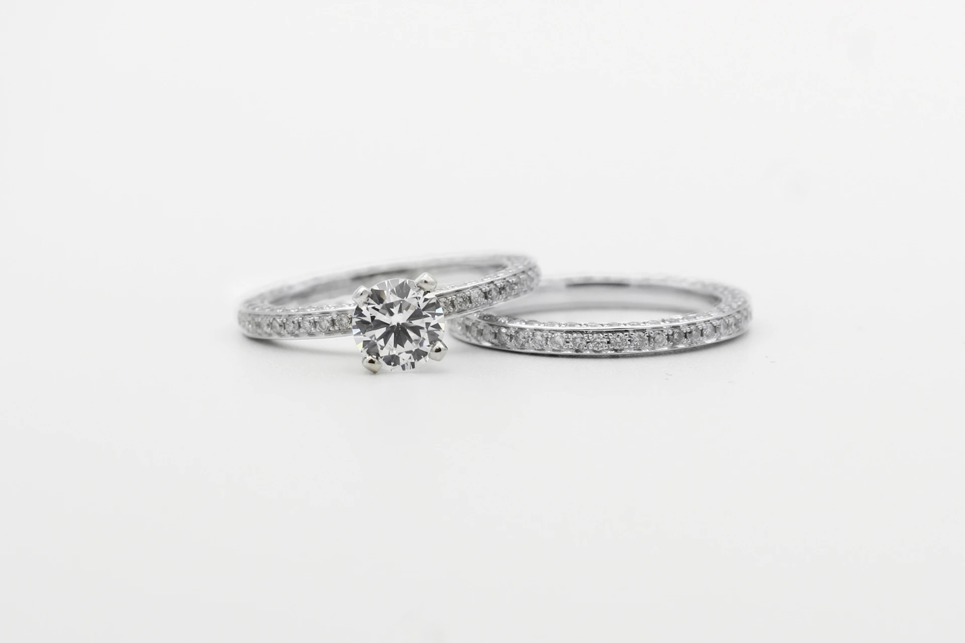 silver diamond studded ring on white surface