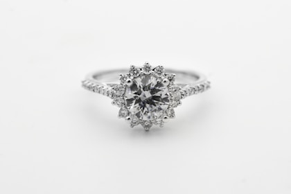 silver diamond studded ring with blue gemstone