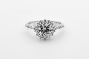 silver diamond studded ring with blue gemstone