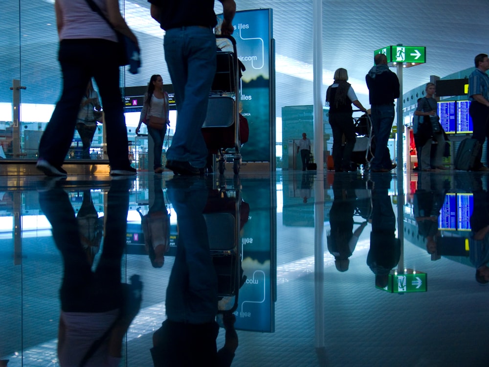 people standing in front of glass wall