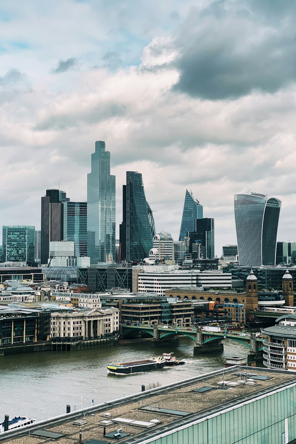 city skyline under white cloudy sky during daytime