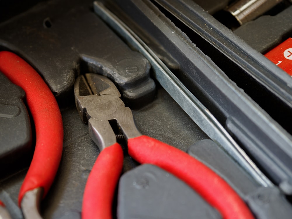 red and black handle stainless steel tool