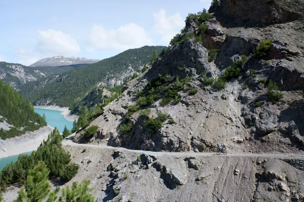 Green and gray mountain beside body of water during daytime — Livigno, Italy