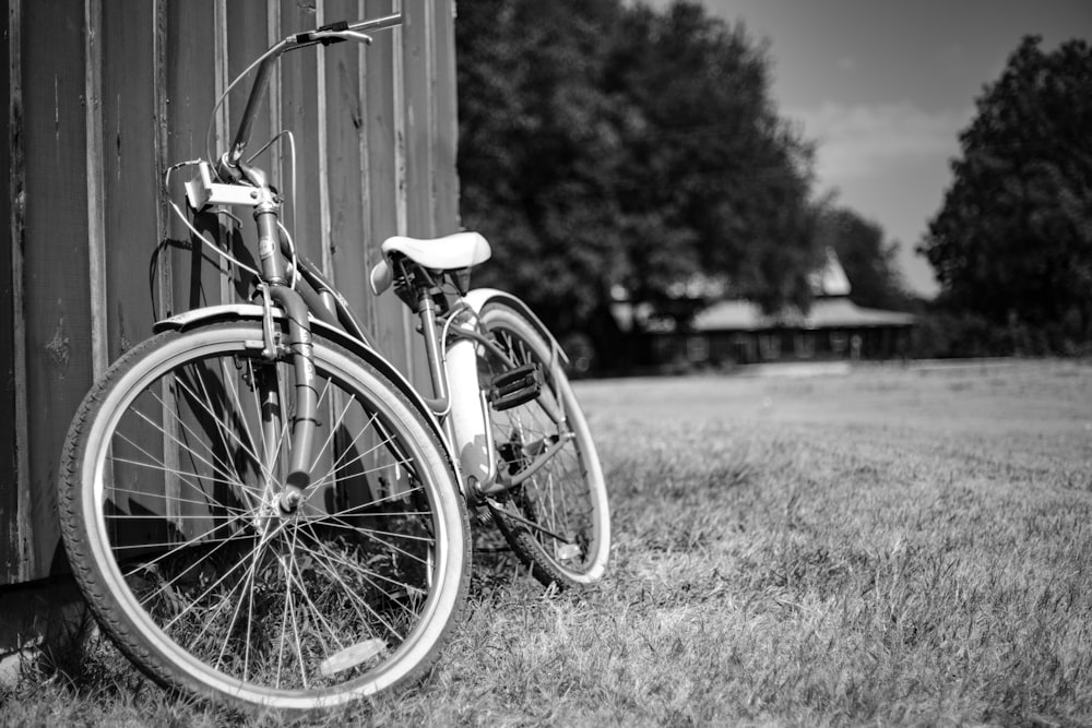 grayscale photo of city bicycle on grass field