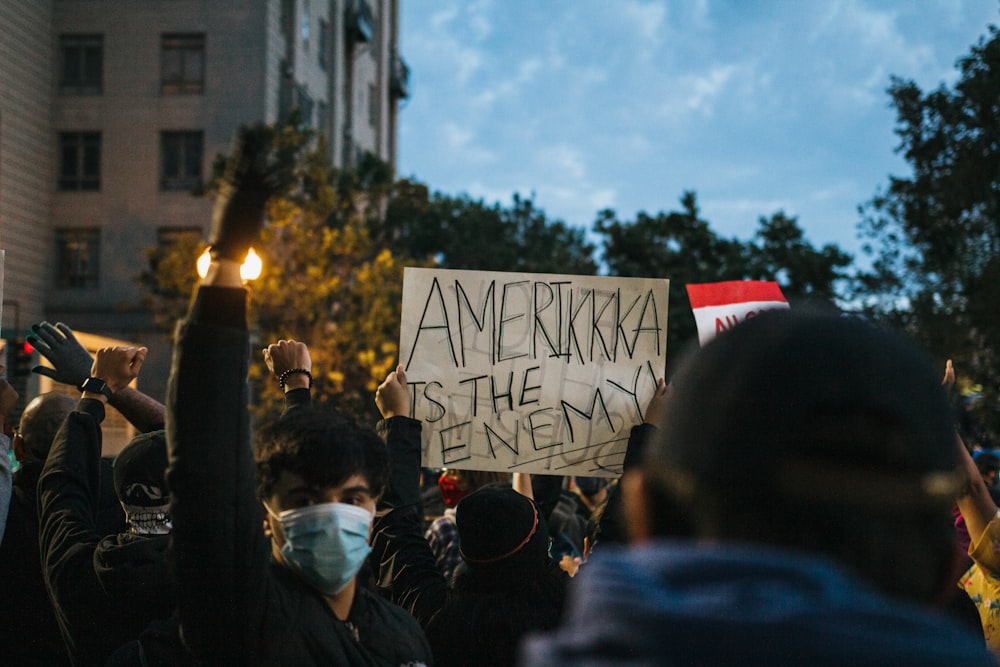 people holding a flag of us a during daytime