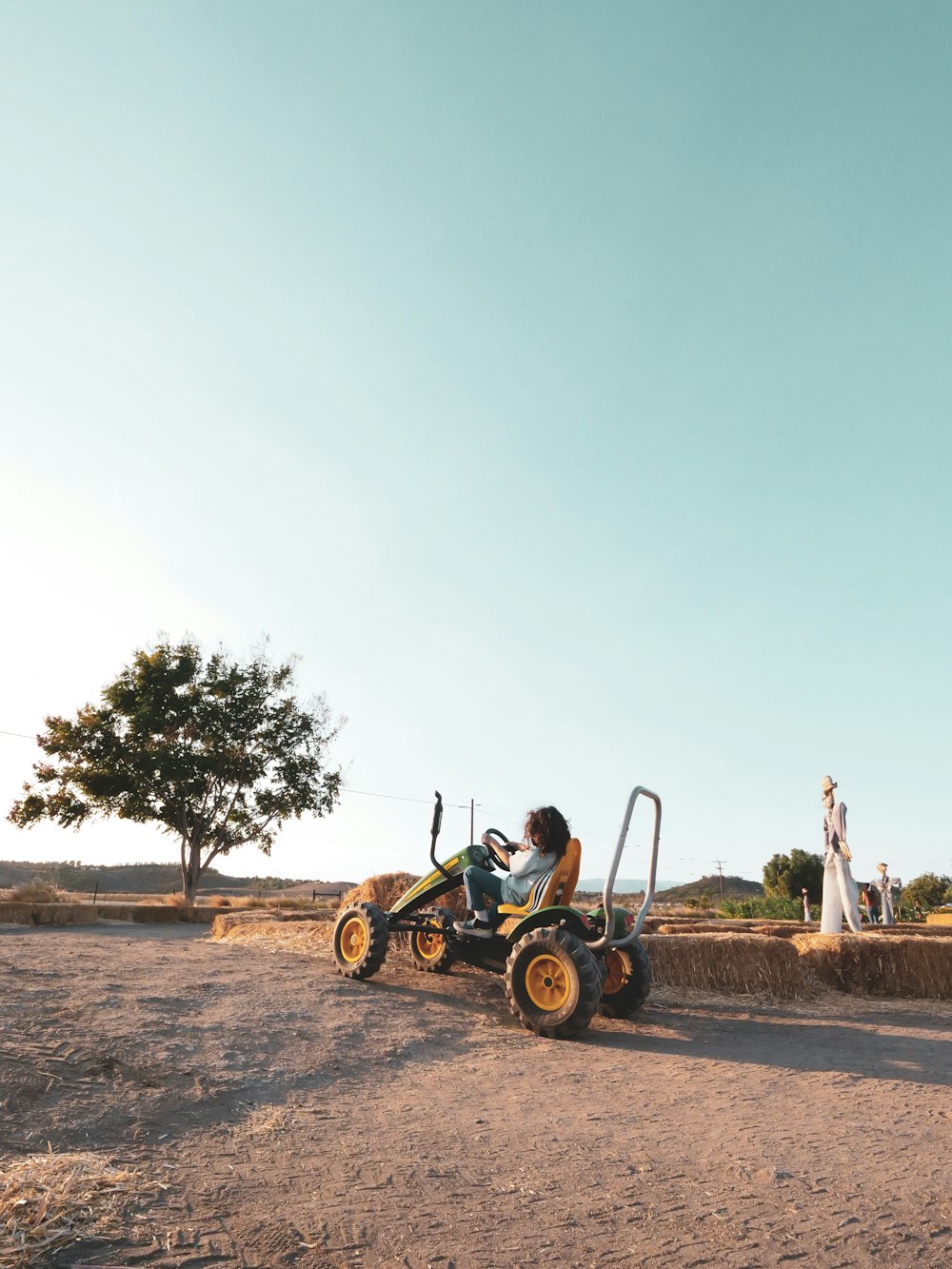 man in green shirt riding on yellow and black dune buggy