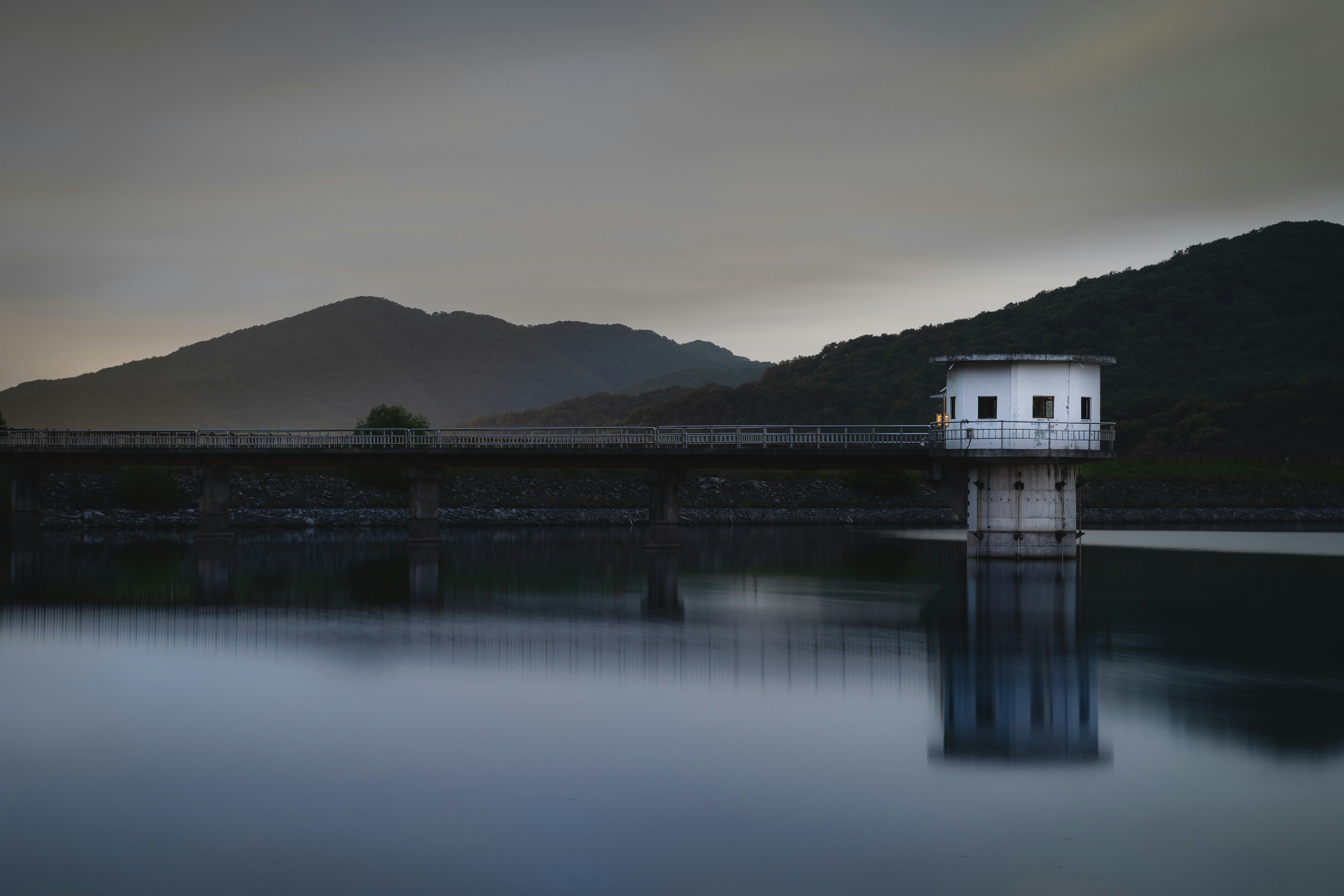 white and black house on dock near mountain during daytime