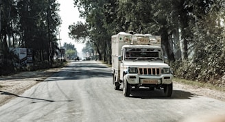 A cherry red and white truck on the road.