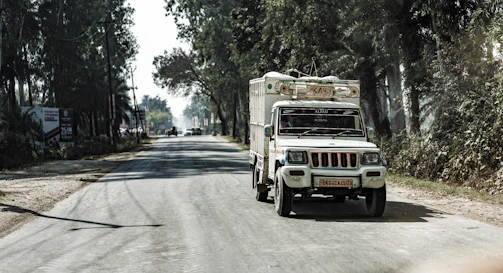 A friendly delivery truck with cdsur 316 logo driving on a sunny road