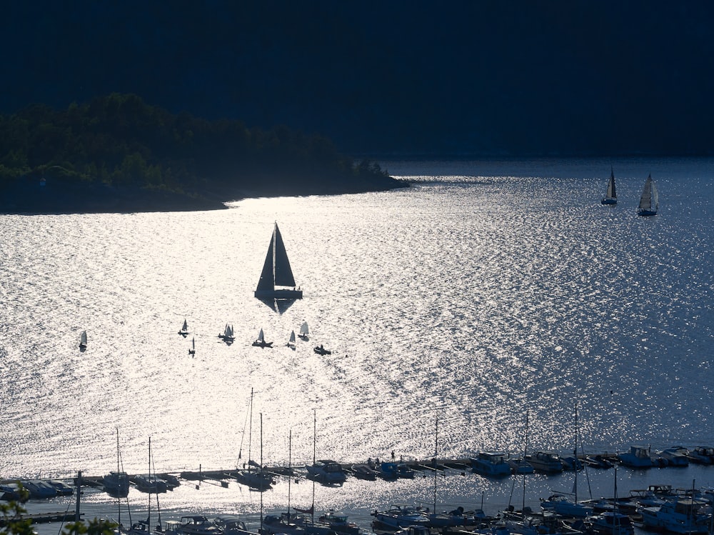 silhouette of sailboat on sea during daytime