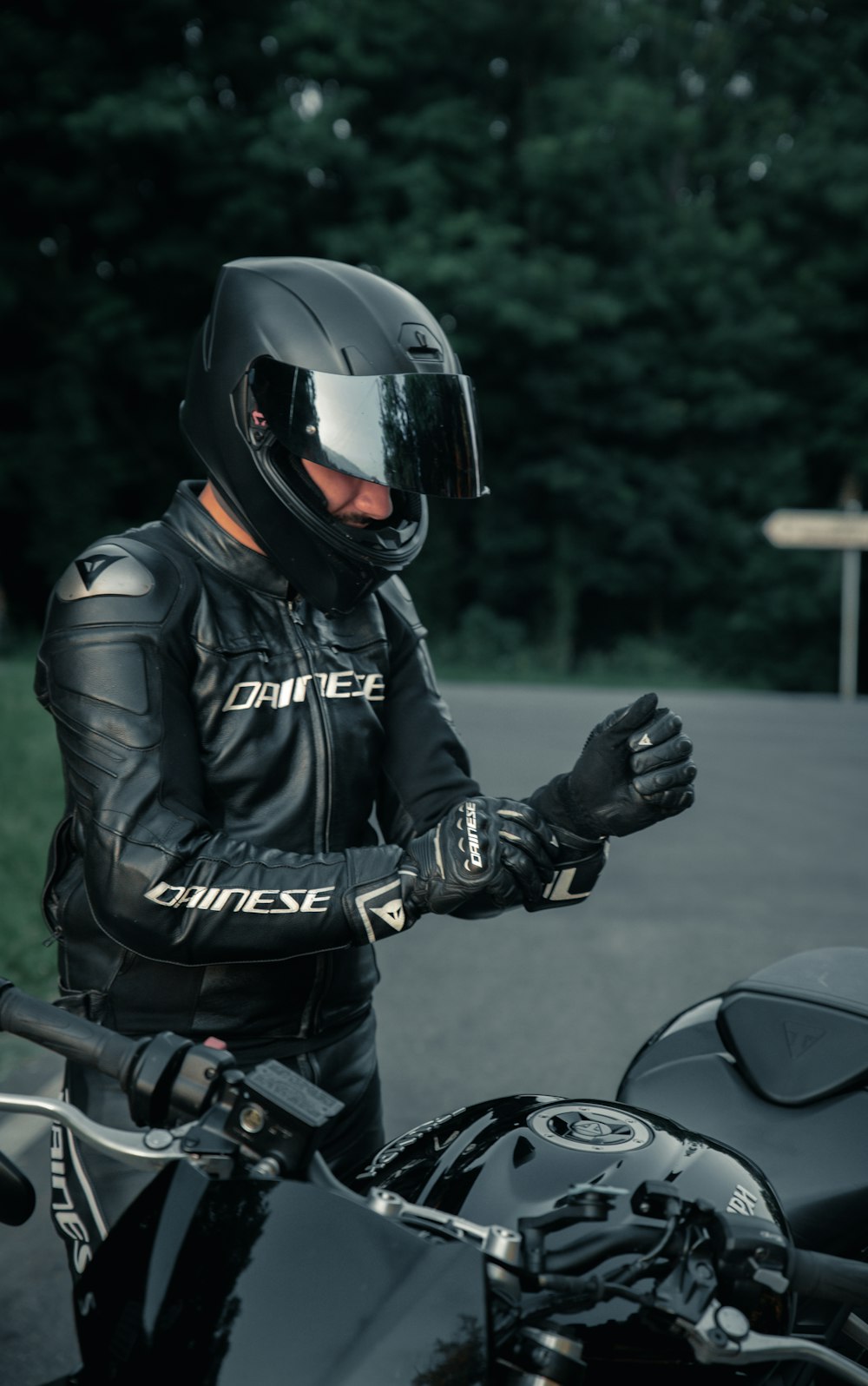 man in black leather jacket riding motorcycle