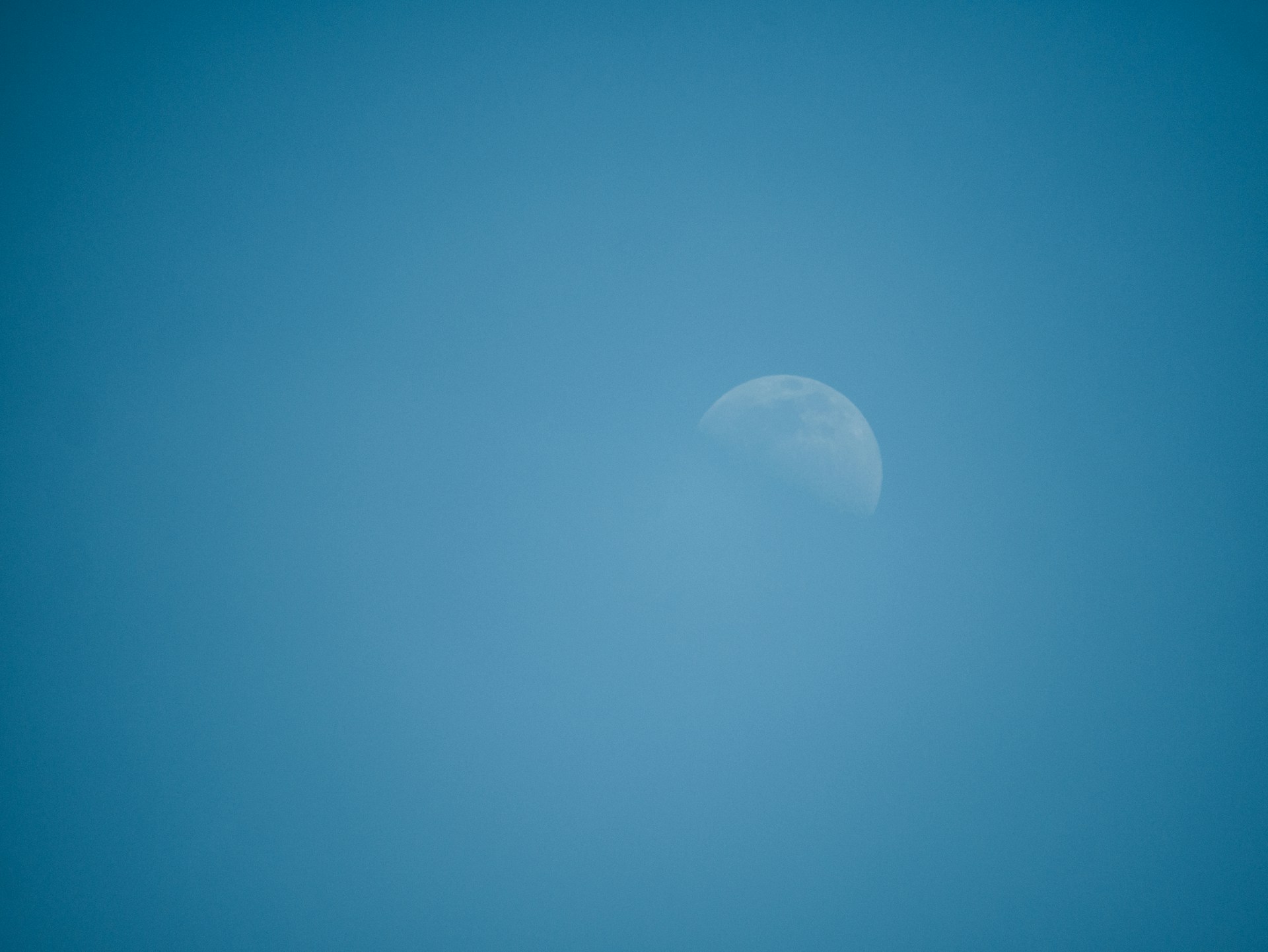 white moon in blue sky