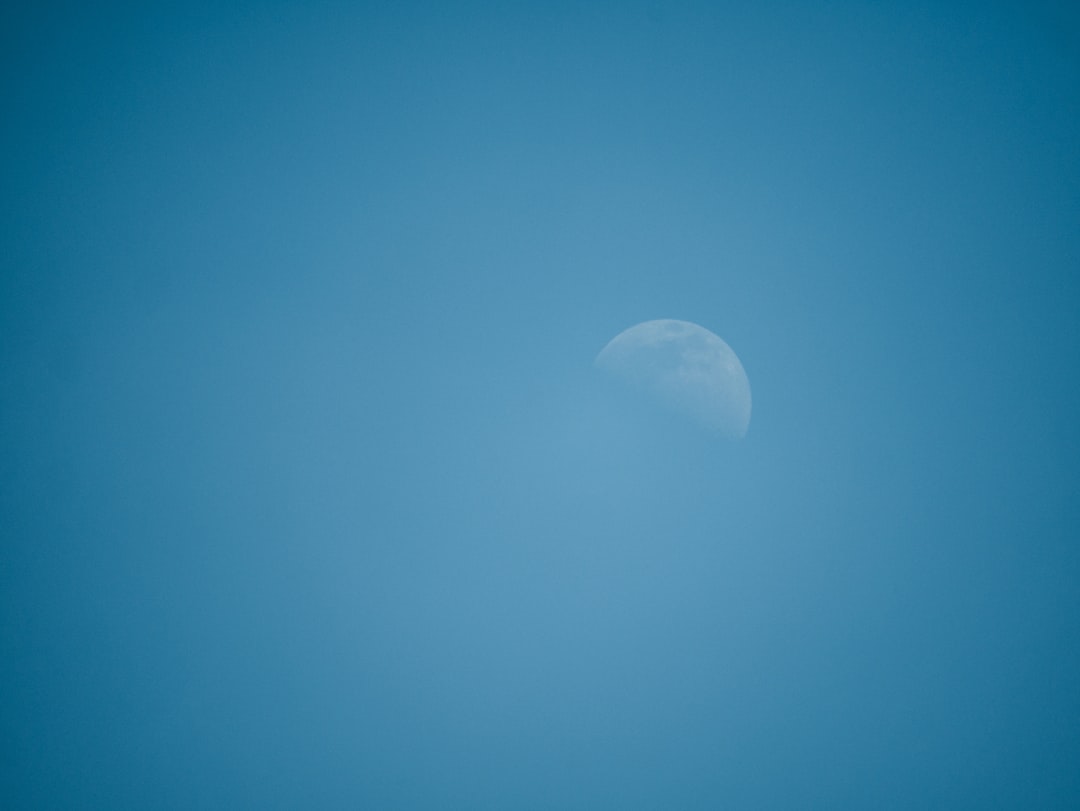 white moon in blue sky