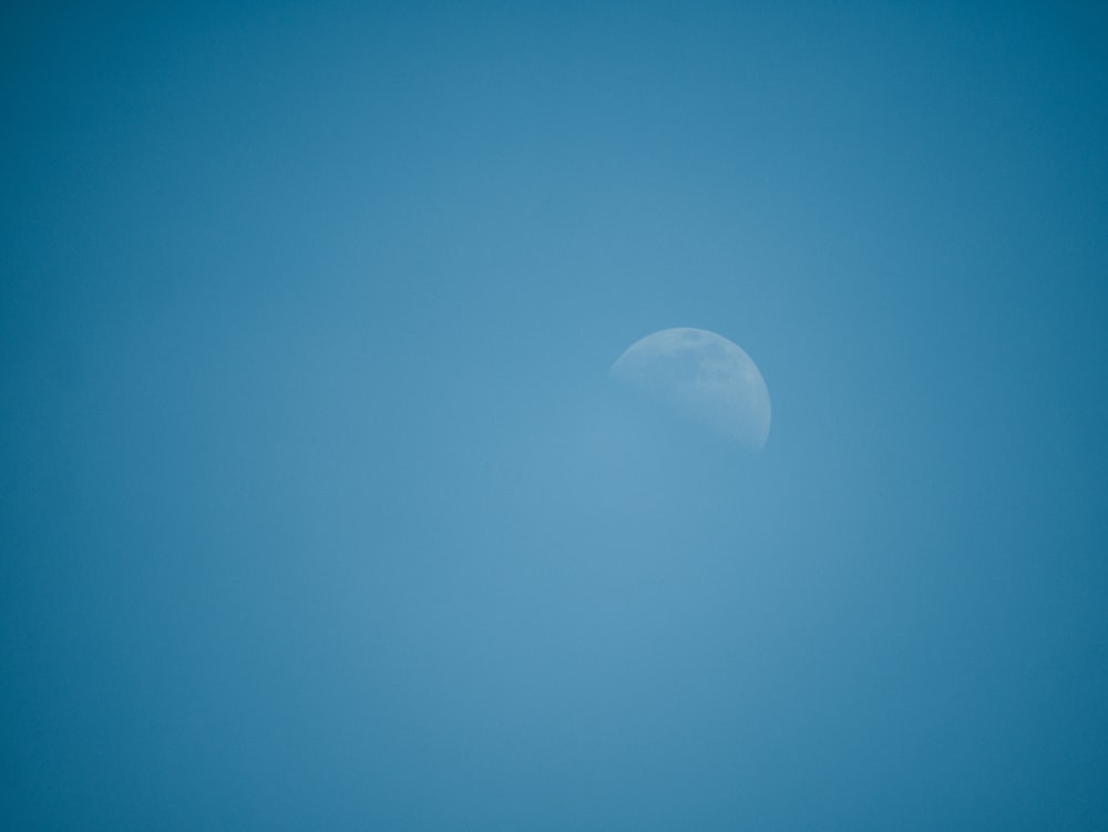 white moon in blue sky