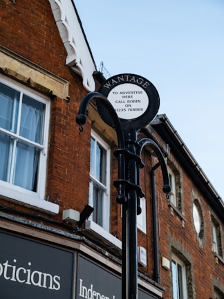 brown brick building with black metal gate
