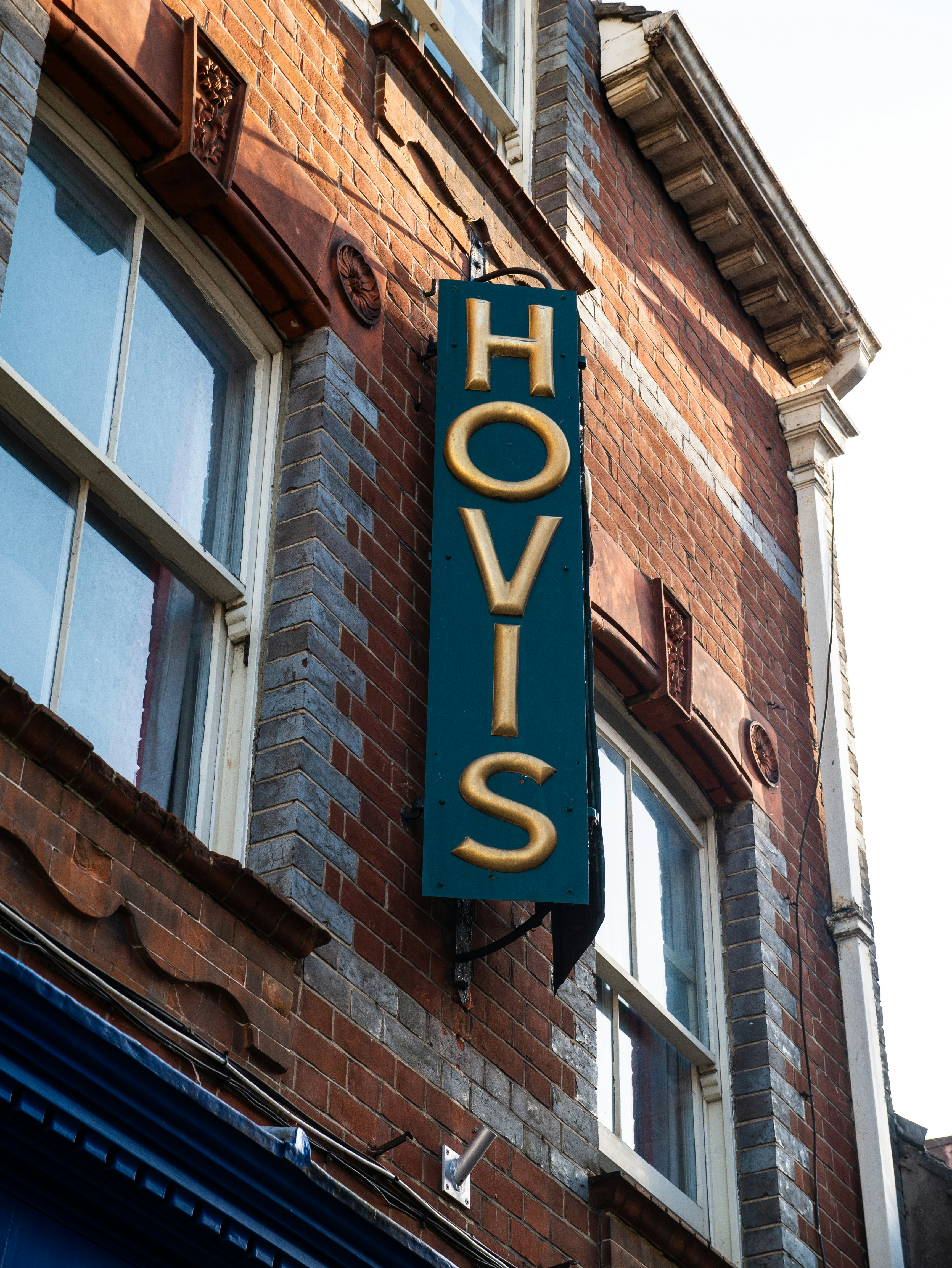 a sign on the side of a brick building