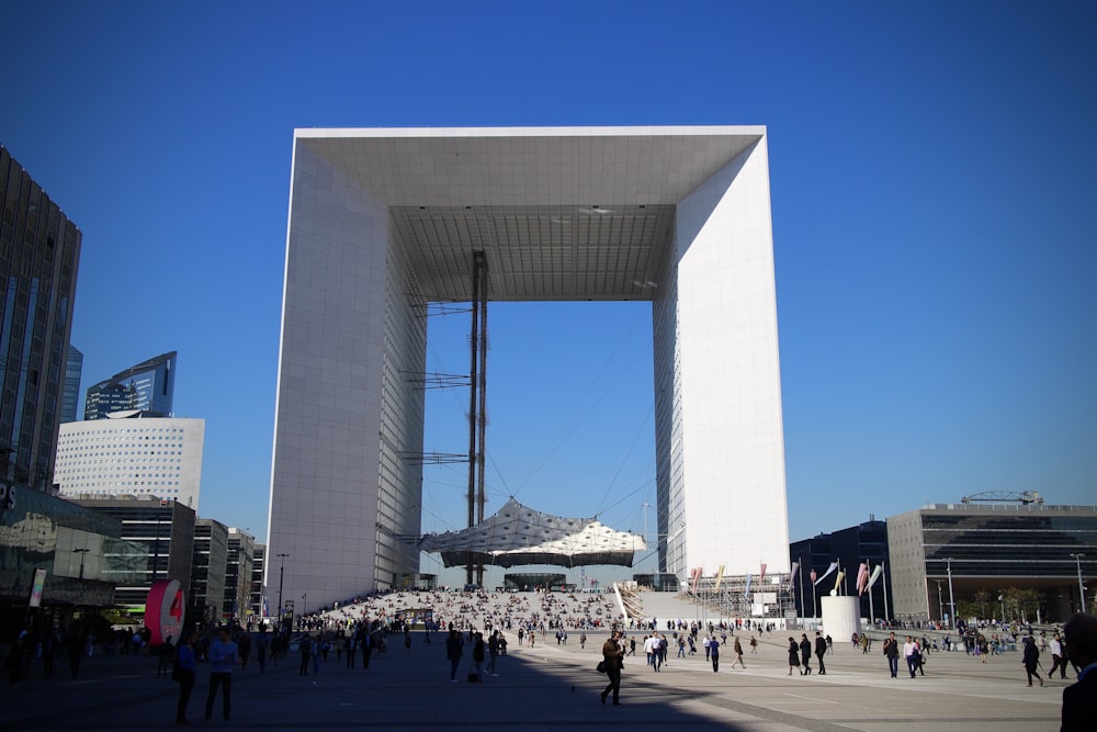 people walking on street near white concrete building during daytime