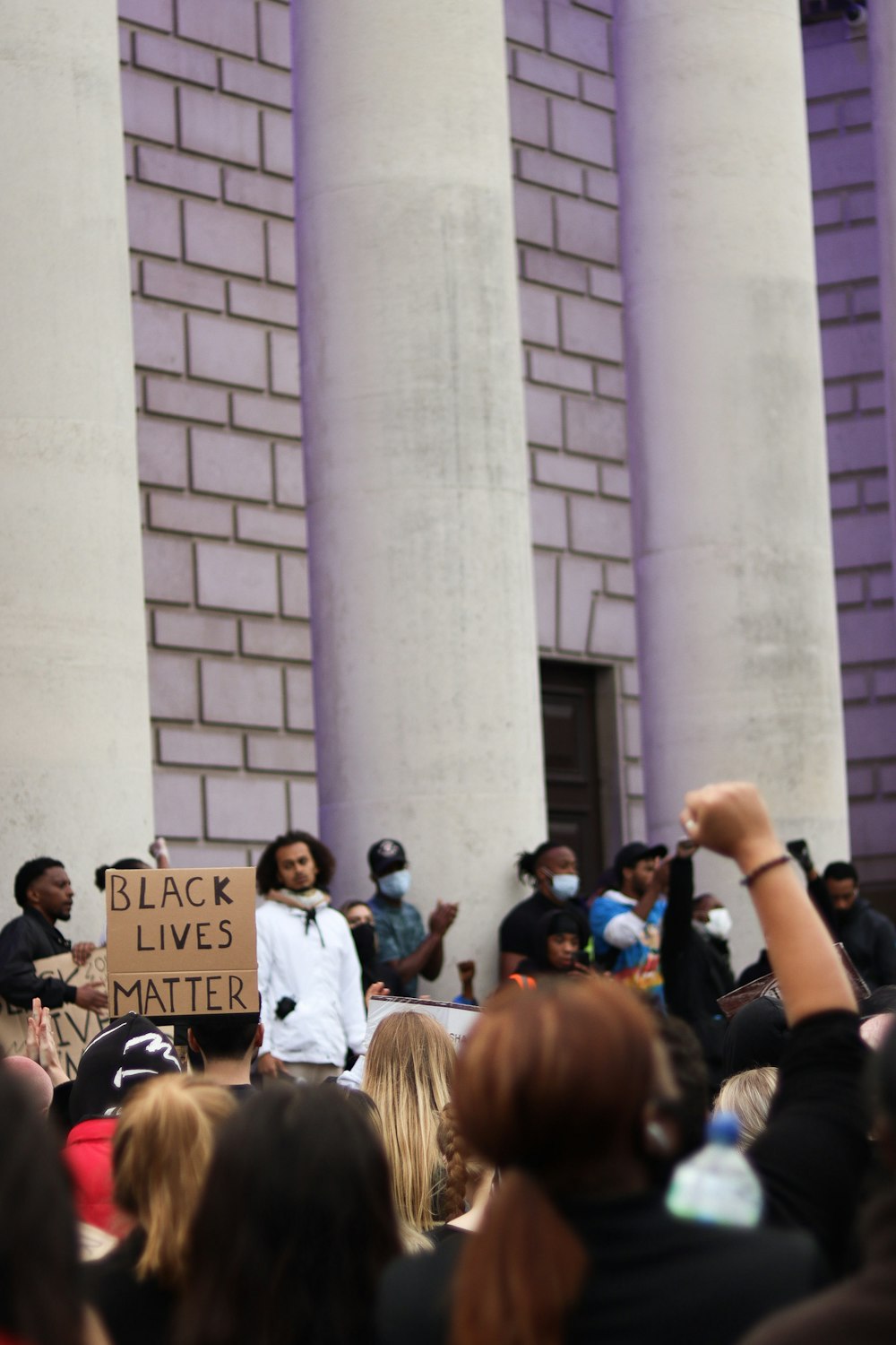 people standing near white concrete building during daytime