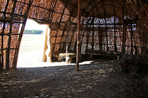 Community members building a meditation shelter with natural materials.