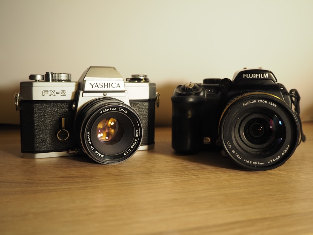 black and silver nikon dslr camera on brown wooden table