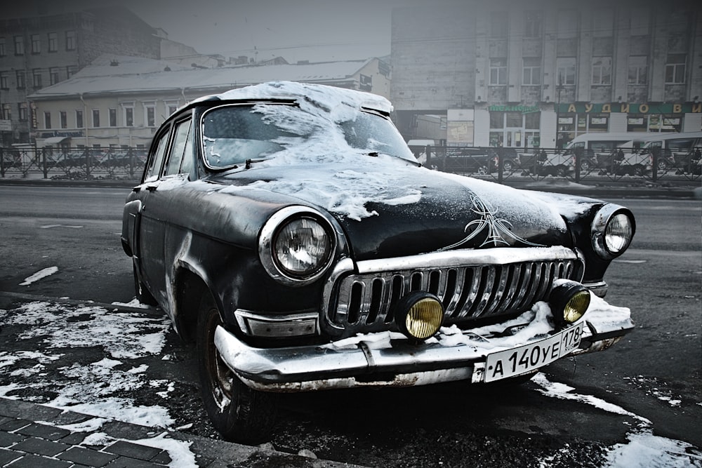 grey classic car parked near building