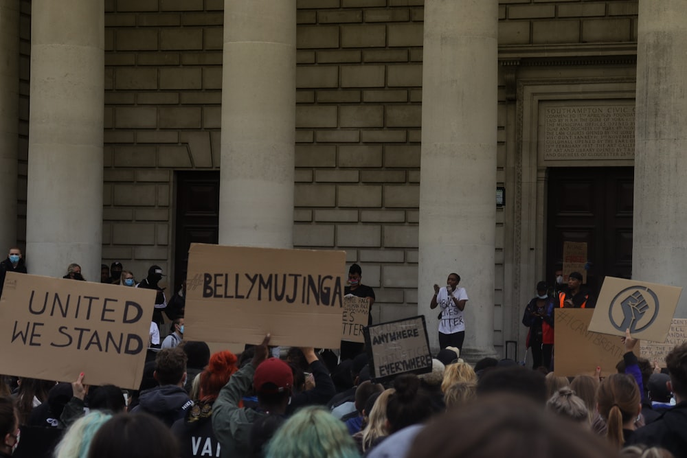 people standing near brown concrete building during daytime