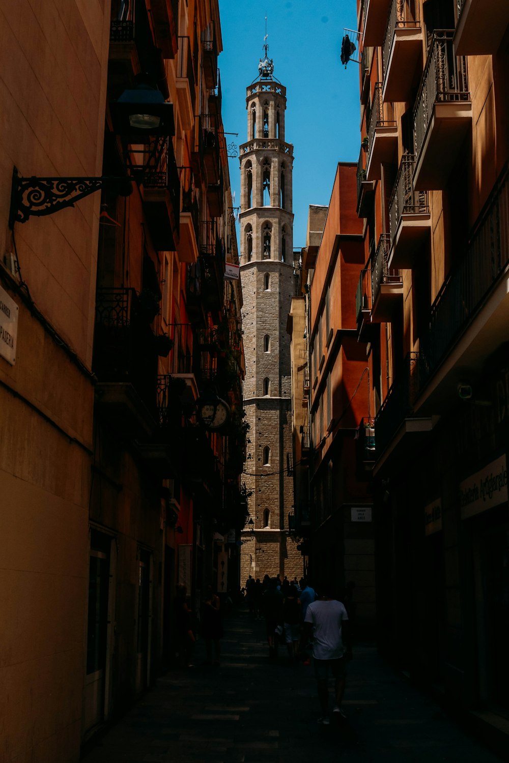 people walking on street between high rise buildings during daytime