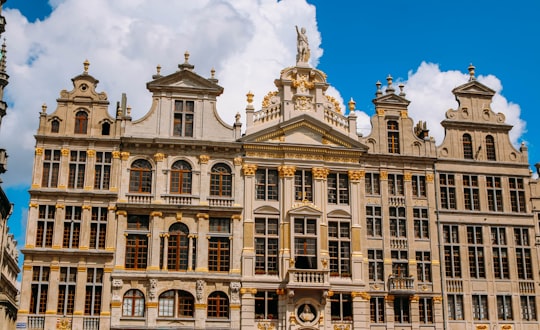 beige concrete building under blue sky during daytime in Grand Place Belgium