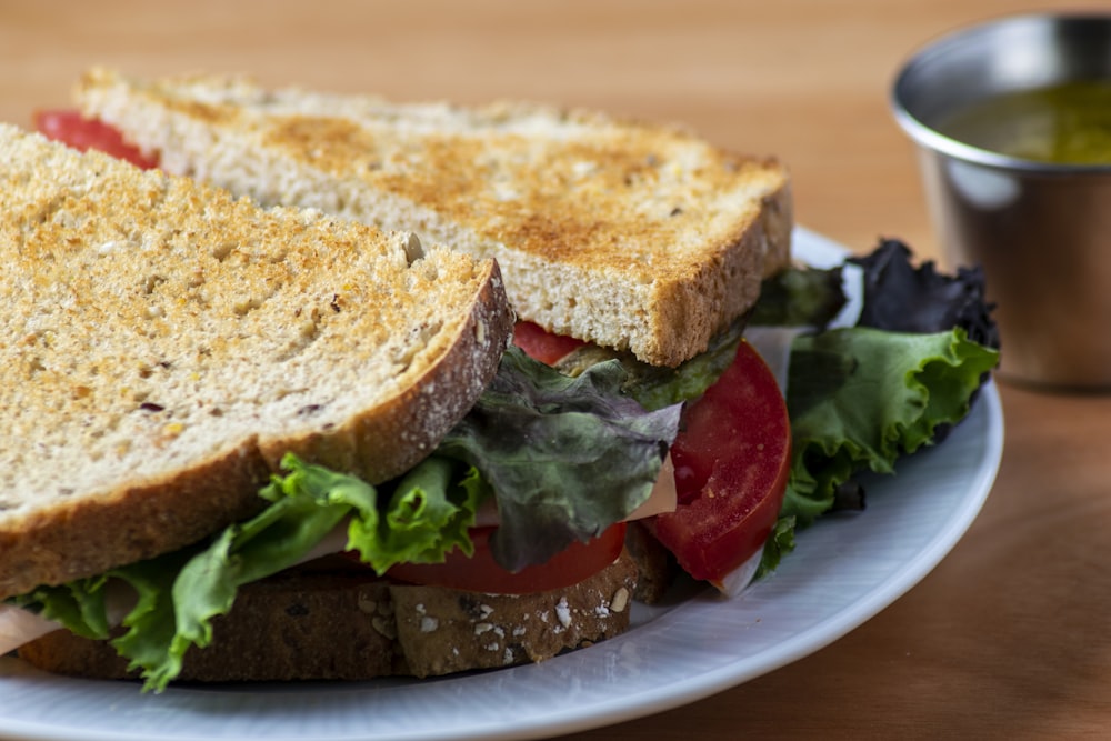 bread with lettuce and tomato on white ceramic plate