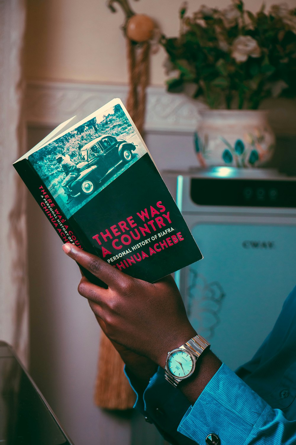 person holding green and white book